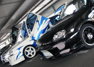 modified cars with custom paint jobs in a line